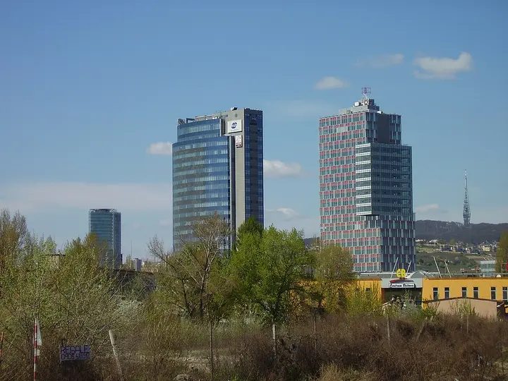 Modern towers rising above trees in Bratislava.