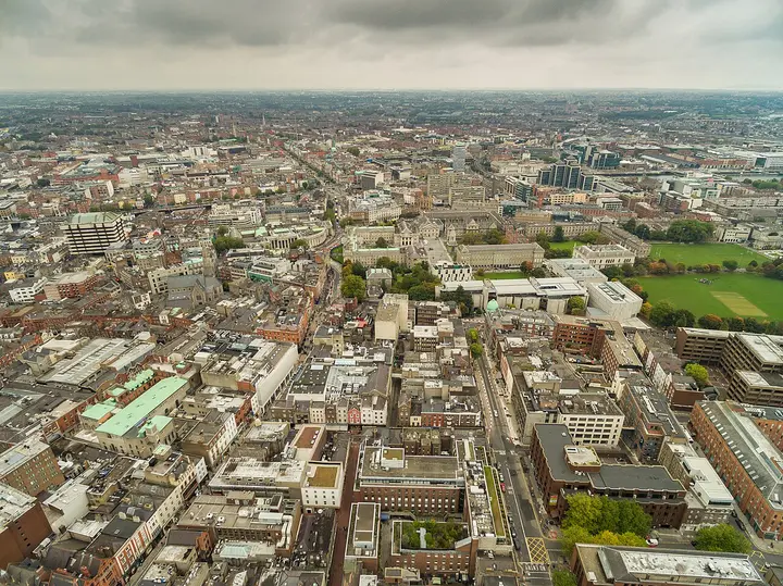 Aerial view of Dublin streets, buildings and green spaces.