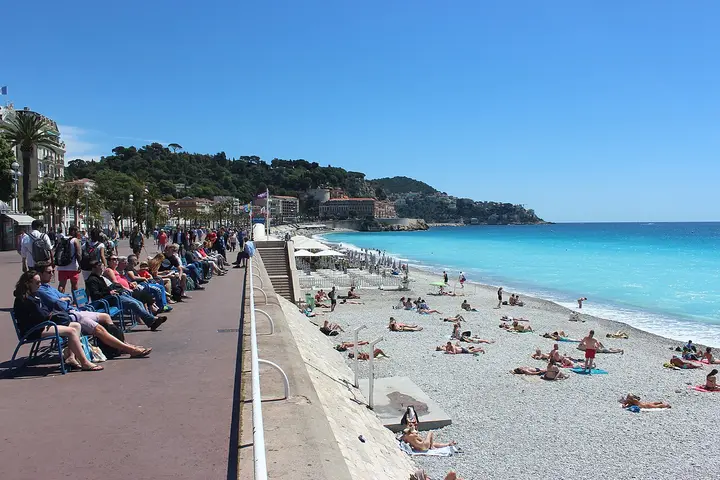 Beach, seafront promenade and hillside buildings in Nice.
